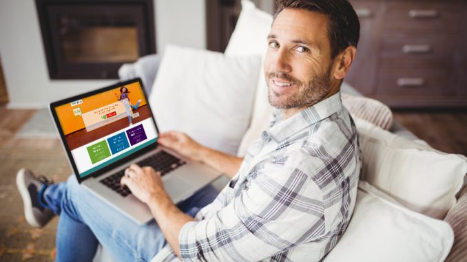 Portrait of smiling man using laptop